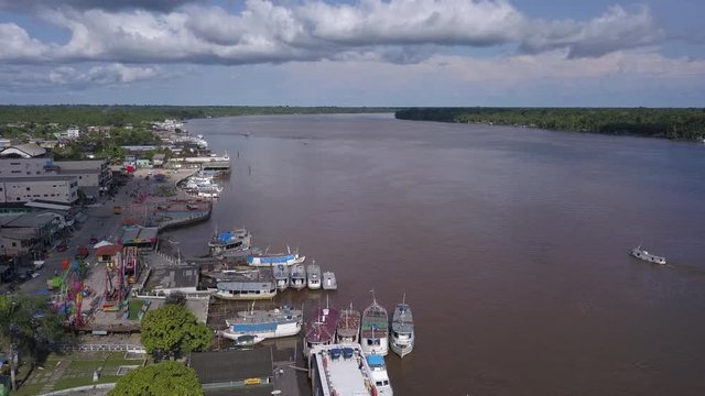 Drone aerial view of Breves city, Para, Brazil. Streets, houses and river with wooden boats on sunny summer day in the Amazon rainforest. Concept of environment, ecology, travel and climate change.4K.