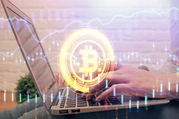 Double exposure of woman hands typing on computer and crypto market theme hologram drawing....