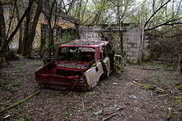 old wreck car located in a forest or ruinlike environment hillbilly