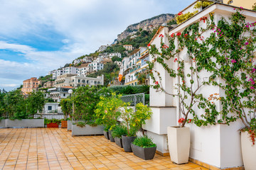 Fototapeta na wymiar Amazing view of the colorful garden on terrace of hotel, Amalfi coast