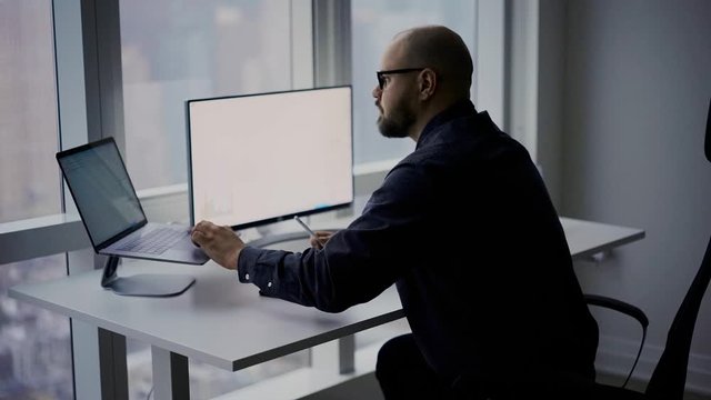 Millennial man doing online browsing during web work with revenue statistics or crypto currency chart, businessman checking banking commerce for analyzing 
