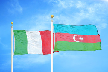 Italy and Azerbaijan  two flags on flagpoles and blue cloudy sky