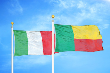 Italy and Benin  two flags on flagpoles and blue cloudy sky