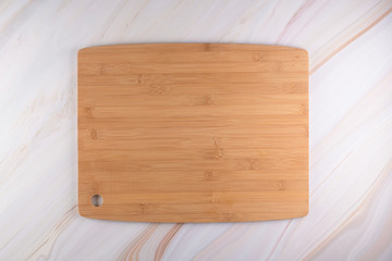 Wooden cutting board on a gray marble background