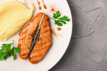 salmon steak with mashed potatoes and herbs top view