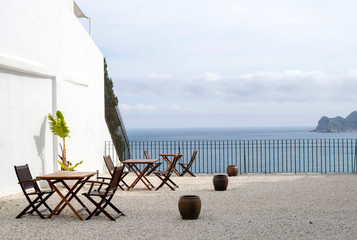 outdoor terrace decorated in a minimalist style, overlooking the sea