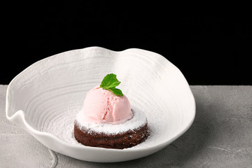 White plate with chocolate fondant with ice cream and mint close up. Lava cake recipe