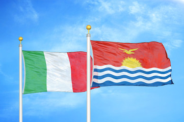 Italy and Kiribati two flags on flagpoles and blue cloudy sky