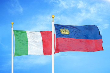 Italy and Liechtenstein two flags on flagpoles and blue cloudy sky
