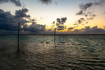 red de voleibol en el mar caribe, amanecer con cielo parcialmente nublado 