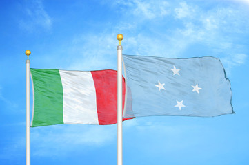 Italy and Micronesia two flags on flagpoles and blue cloudy sky