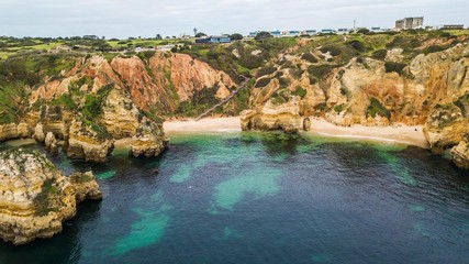Aerial view of Camilo beach, in Lagos, Algarve, Portugal. Cliff and rocks in the sea at Praia do Camilo, Algarve region, Portugal