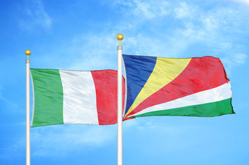 Italy and Seychelles two flags on flagpoles and blue cloudy sky