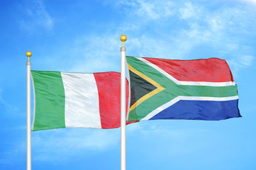 Italy and South Africa two flags on flagpoles and blue cloudy sky