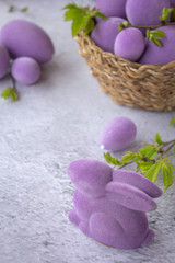 easter purple eggs with rabbit on a light surface