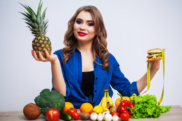 Woman makes a choice between healthy and harmful food.