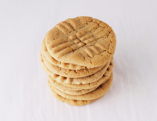 Stack of peanut butter cookies isolated on white background.