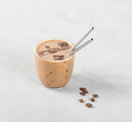 Cold iced coffee with milk on a light background 