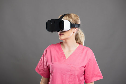 Portrait of attractive female nurse wearing virtual reality goggles