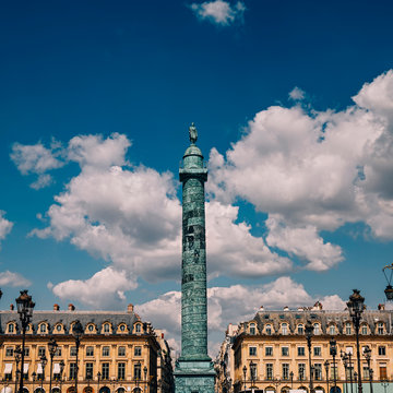 Statue Of Napoleon In Vendome Square In Paris, France against blue sky with clouds in summer 