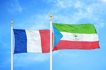 France and Equatorial Guinea two flags on flagpoles and blue cloudy sky