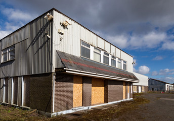 Fototapeta premium Closed and boarded up commercial buildings on an industrial estate