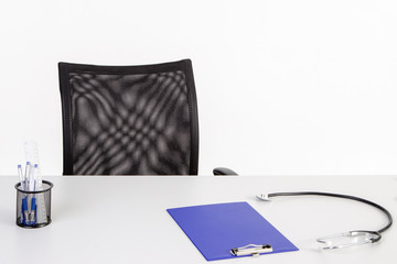 The doctor's office. Phonendoscope and tablet on the white table.