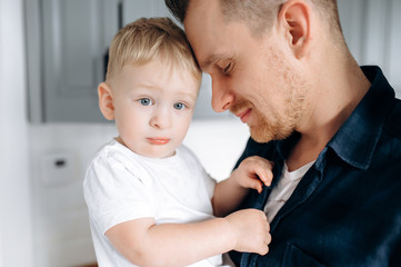 Sensual photo of dad and son. Dad gently hugs his beloved little son