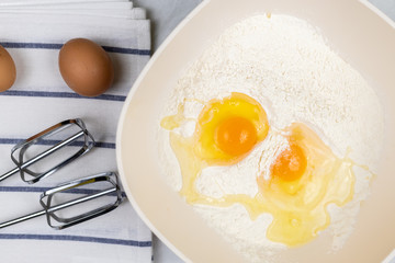 Top view of smashed eggs in flour ready for creating dough
