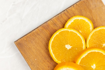 Flat lay above sliced orange on the cutting board with copy space