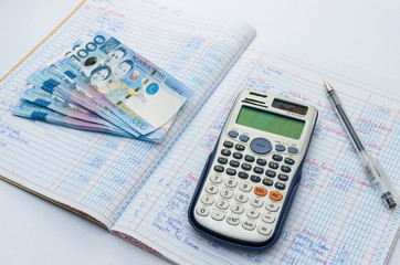 One thousand Philippine peso with a scientific calculator and a white columnar sheet on the back