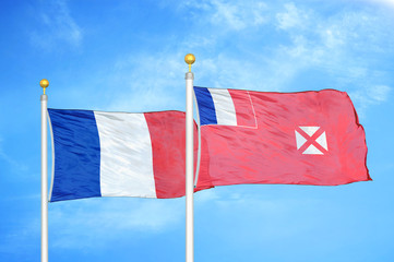 France and Wallis and Futuna two flags on flagpoles and blue cloudy sky
