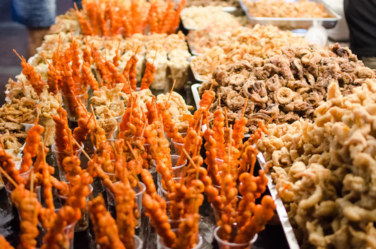 Assorted street food in bright orange colors
