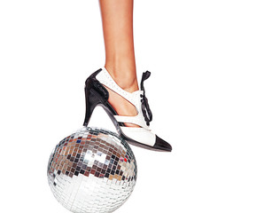 Dance shoes and disco ball isolated against white background.