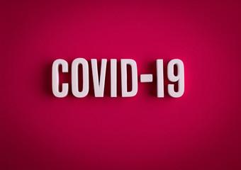 COVID-19 coronavirus sign lettering on a colored background