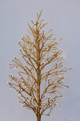 Christmas decoration glowing golden metal tree garland. Home decor, luminous tree