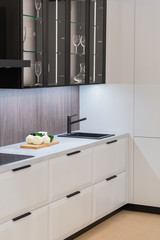 Contemporary luxury kitchen design in white color with black tap