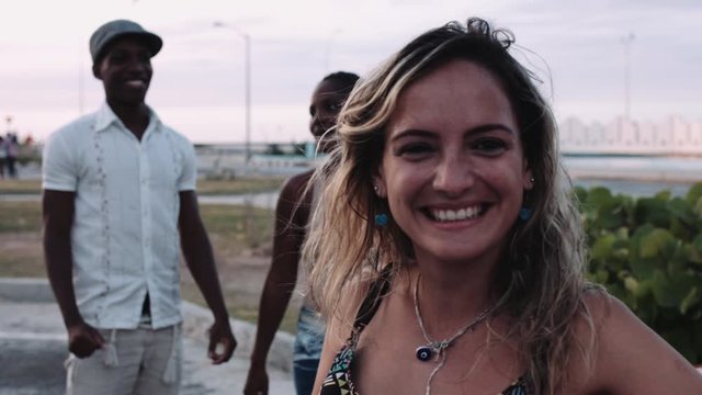 Young man and women singing and dancing roadside