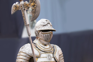 The uniform of a medieval knight with an ax, beautiful armor, decor for the interior.