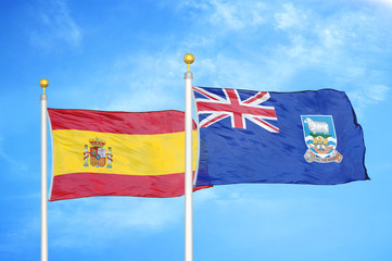 Spain and Falkland Islands two flags on flagpoles and blue cloudy sky