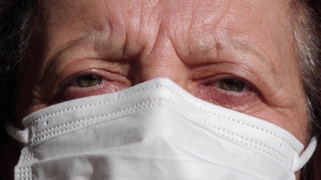 Extreme close-up portrait of middle aged woman wearing protective Concept of health and safety life, N1H1 coronavirus, virus protection. Real people series, shot in 4K.
