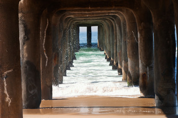 The underside of a pier at the ocean coast.