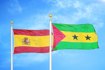 Spain and Sao Tome and Principe two flags on flagpoles and blue cloudy sky
