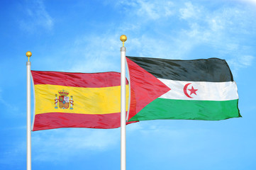 Spain and Western Sahara two flags on flagpoles and blue cloudy sky