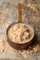 Porridge in Copper Saucepan on Stainless Steel Surface