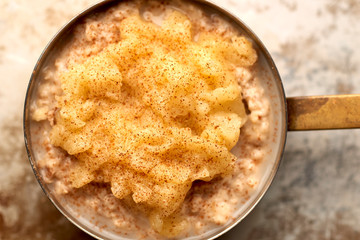 Closeup of Porridge with Mashed Fruit and Cinammon in Saucepan