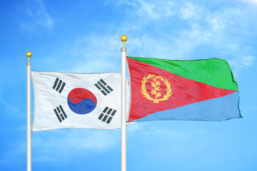 South Korea and Eritrea two flags on flagpoles and blue cloudy sky