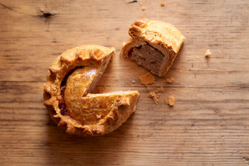 Overhead View of Sliced Meat Pie on Wooden Surface