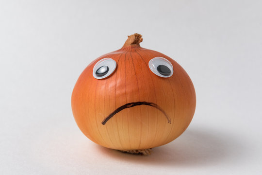 Napiform onion with sad face. Bulb Onion with Googly eyes and sad smile on white background