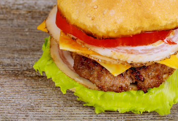 Juicy appetizing burgers with a cutlet, cheese, tomato